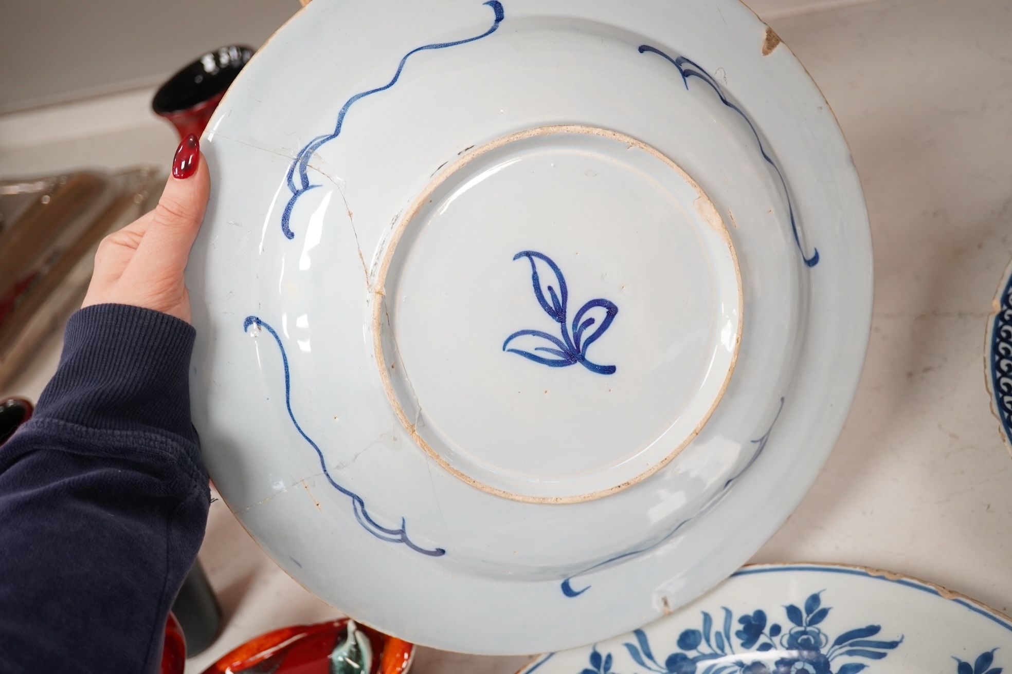 Three 18th century Delft pottery dishes, largest 31cm diameter. Condition - poor to fair